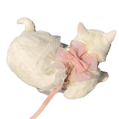 White cat-shaped toy with a pink bow and leash on a white background
