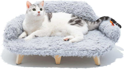 Cat lying on a fluffy gray pet bed with wooden legs against a white background