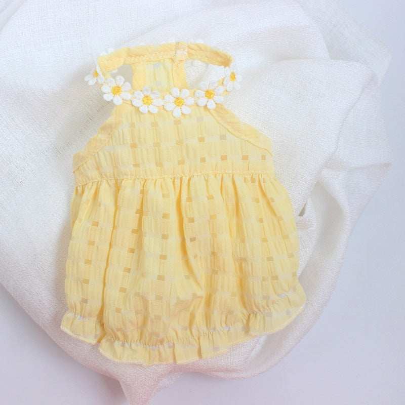 Yellow baby romper with floral details on a white background