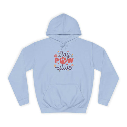 Light blue Printify Stay Pawsitive Unisex Hoodie with colorful paw print graphic and kangaroo pocket