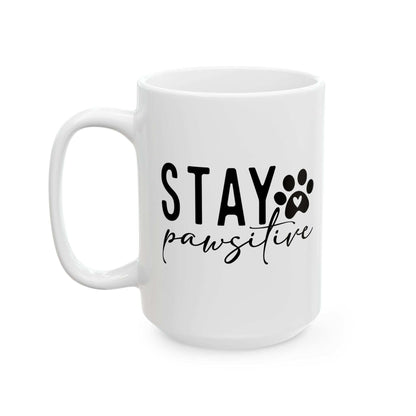 White ceramic Stay Pawsitive Mug with black paw print and text design by Printify