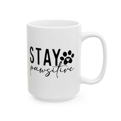 White ceramic Stay Pawsitive Mug with black text and paw print design from Printify