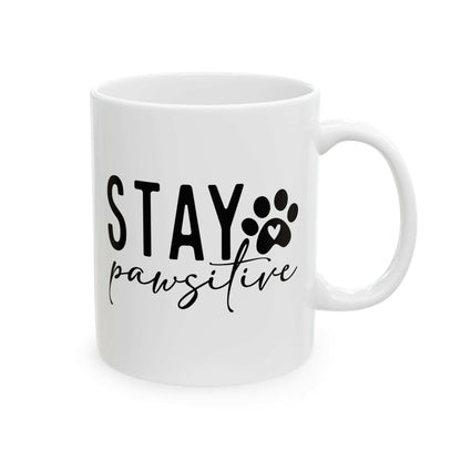 White ceramic Stay Pawsitive Mug with black text and paw print design